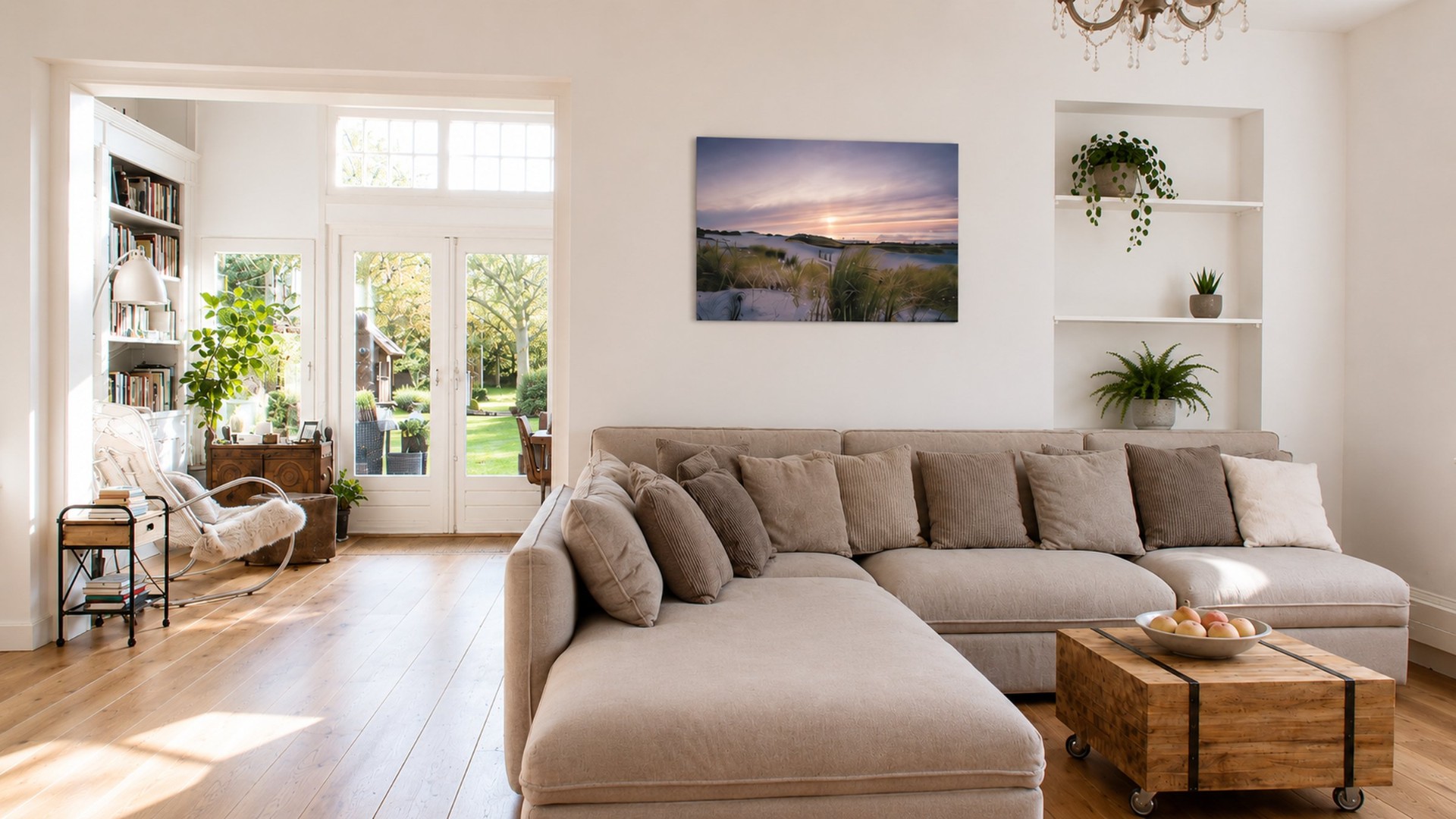 Bright open living room in a renovated Amsterdam home, with wide oak floors, sectional sofa, French doors opening to the garden and a dunes canvas print above