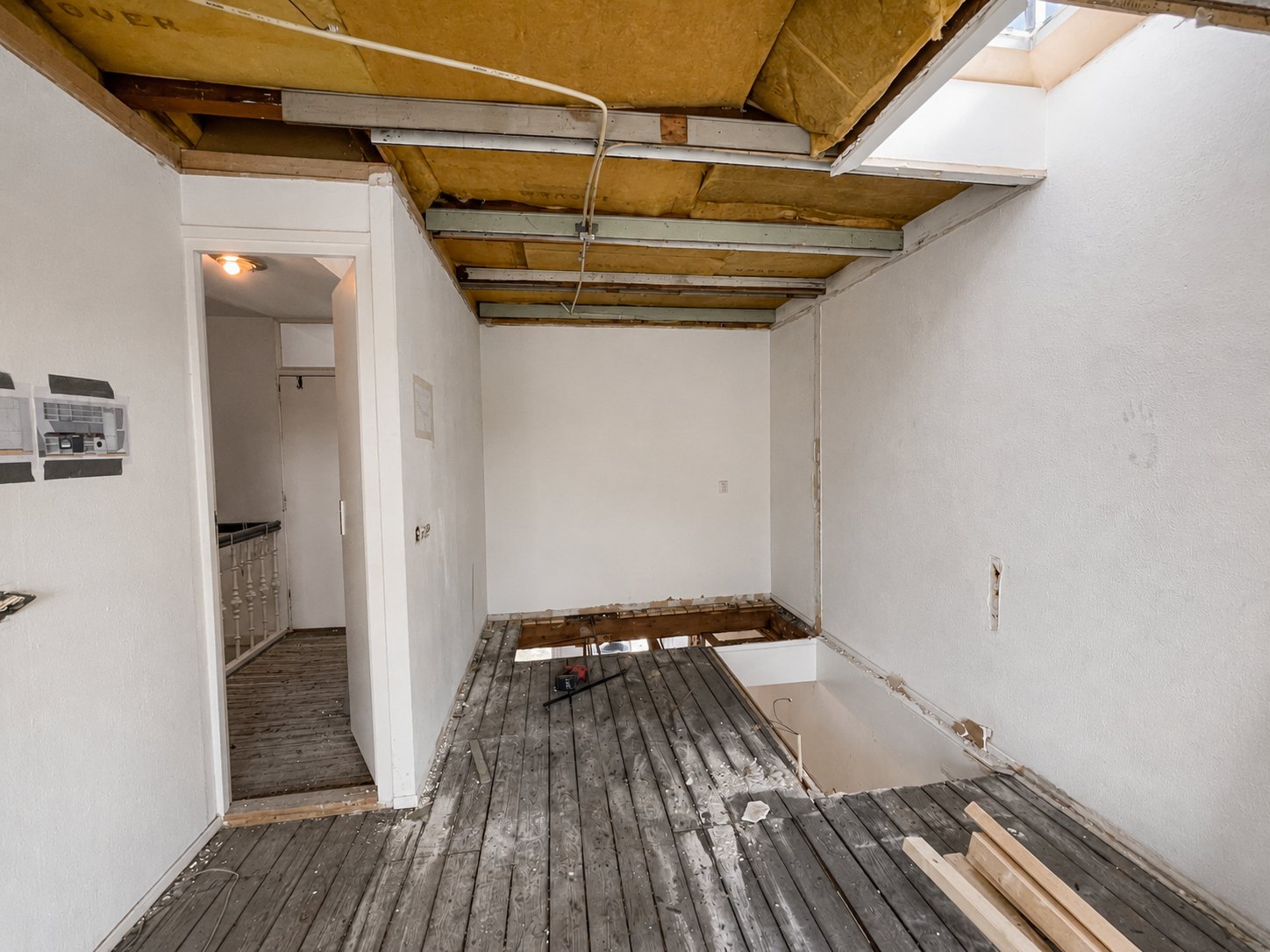 Amsterdam attic apartment before renovation, stripped back with exposed beams and bare floors